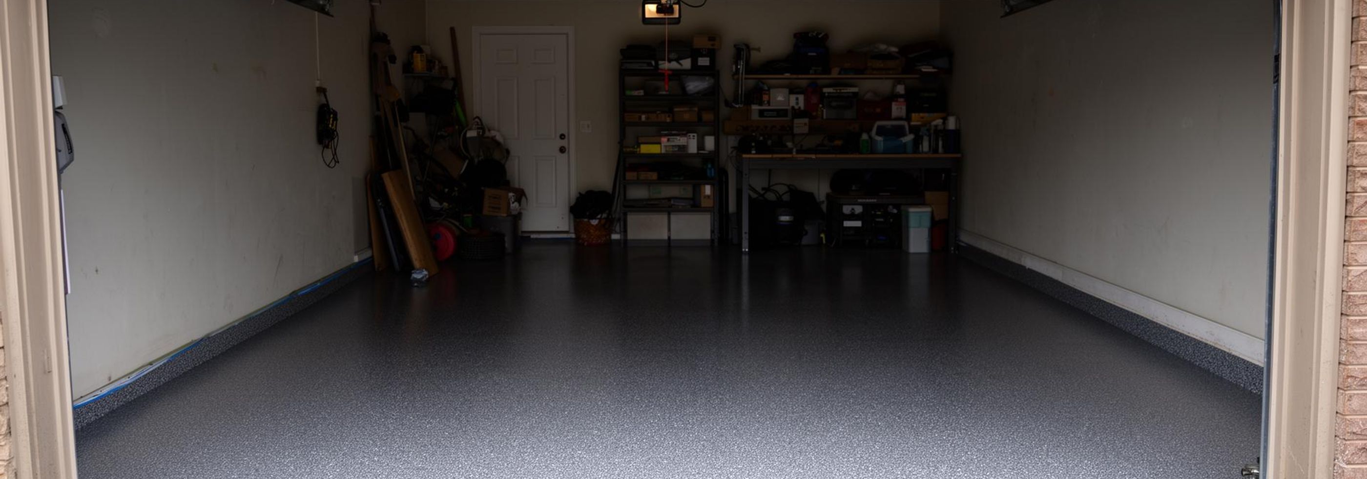 Residential garage floor with glossy grey epoxy concrete coating