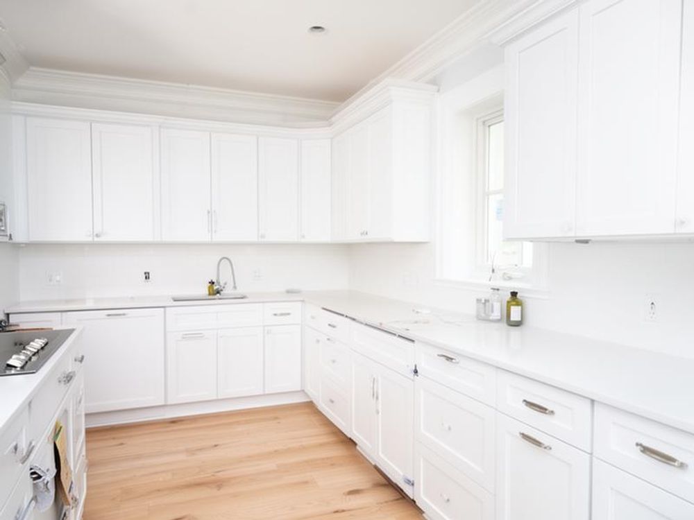 White kitchen cabinets freshly painted in Bridlewood