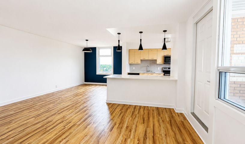 Repainted Ottawa condo with navy blue accent wall and bright white open-concept living area