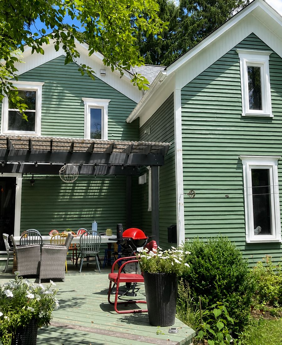 Country home with soft green siding, crisp white trim, and refreshed soffits in Kemptville