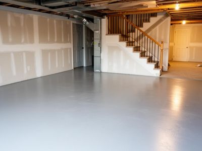Freshly painted light grey basement concrete floor