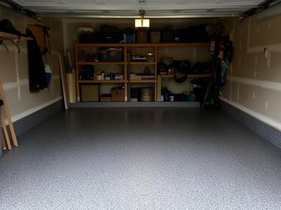 Glossy grey epoxy coating on a residential garage floor